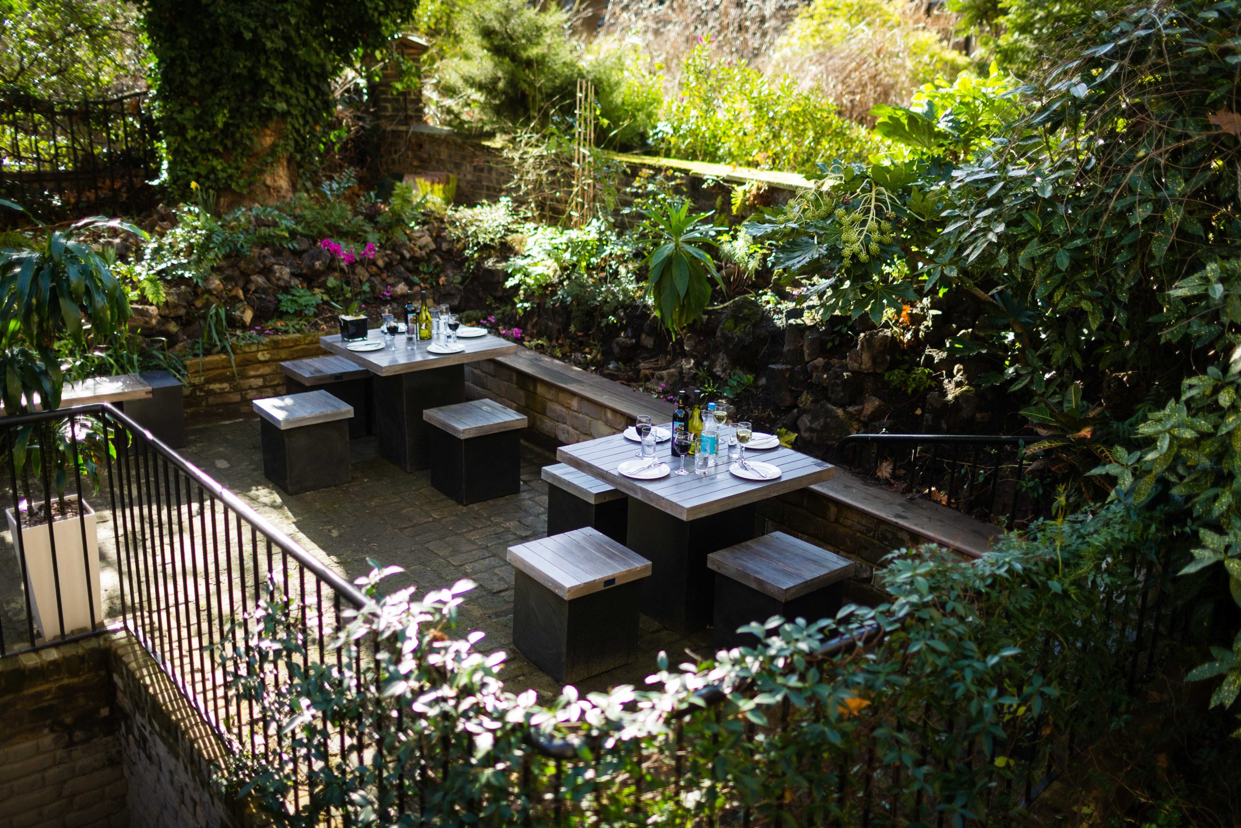 Photo of a garden with tables and chairs