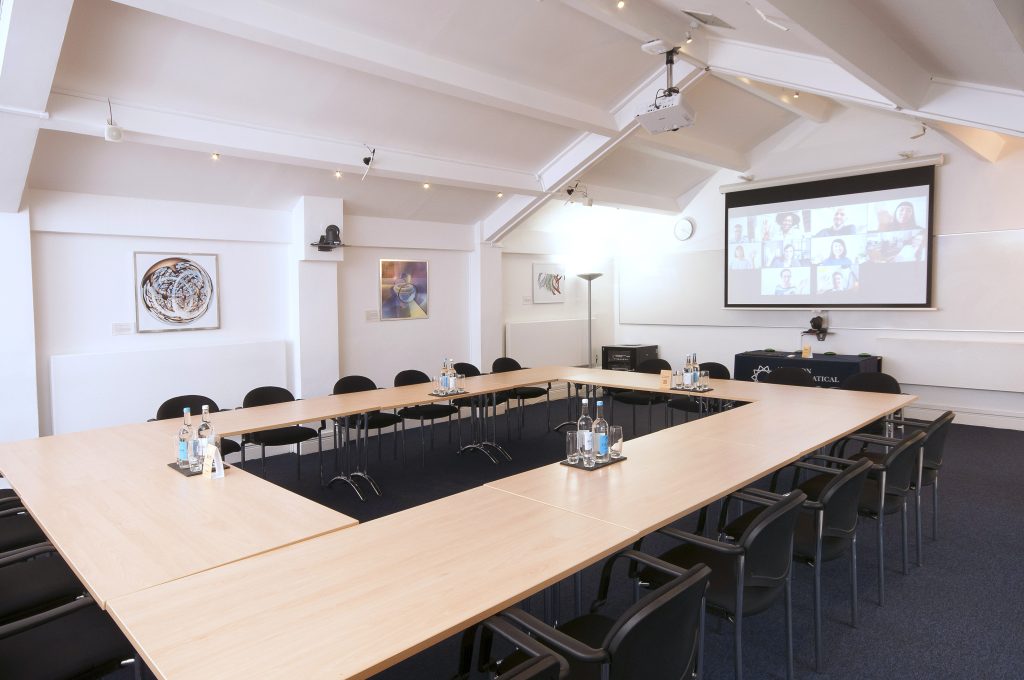 Photo of a large meeting room in a boardroom layout